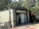 Beige Metal Lockable Storage Shed With Single Garage Door, A-frame Roof. Fixed Price $1200.00.
